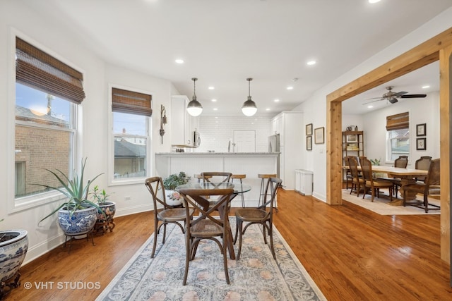 dining space featuring ceiling fan and light wood-type flooring