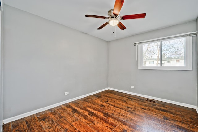 empty room featuring dark hardwood / wood-style floors and ceiling fan