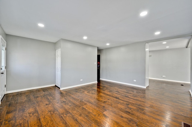 spare room with dark hardwood / wood-style floors