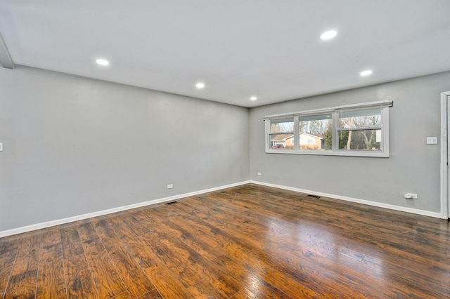 unfurnished room featuring dark hardwood / wood-style flooring