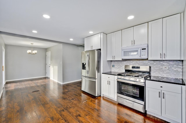 kitchen with stainless steel appliances, an inviting chandelier, tasteful backsplash, dark hardwood / wood-style floors, and white cabinets