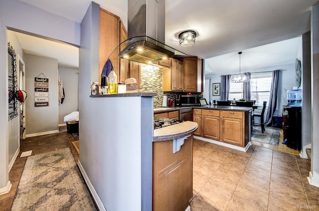 kitchen with backsplash, decorative light fixtures, kitchen peninsula, island exhaust hood, and stainless steel appliances