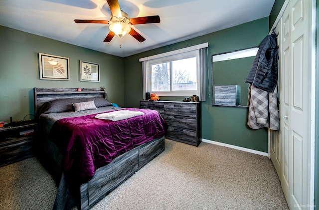 carpeted bedroom featuring ceiling fan and a closet