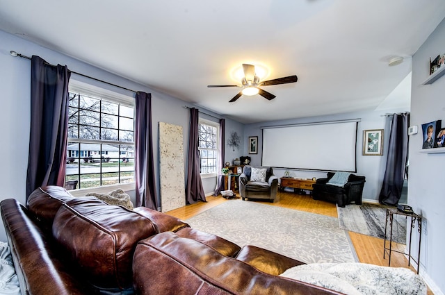 living room with ceiling fan and light hardwood / wood-style flooring