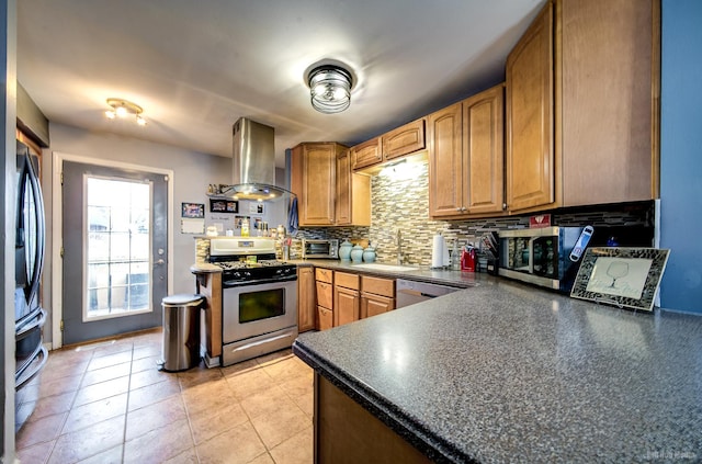 kitchen featuring backsplash, sink, light tile patterned floors, island range hood, and stainless steel appliances