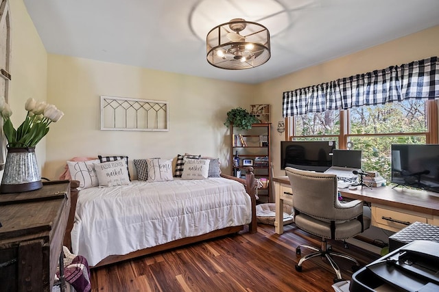 bedroom with dark hardwood / wood-style floors