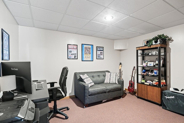 carpeted office space featuring a paneled ceiling