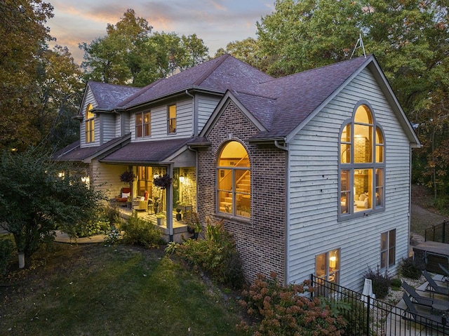 view of front of house with a patio and a lawn