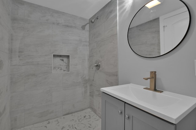 bathroom featuring vanity and tiled shower