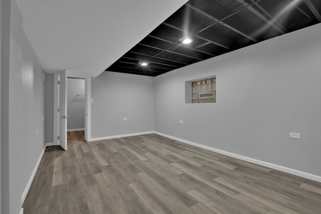 basement with hardwood / wood-style flooring