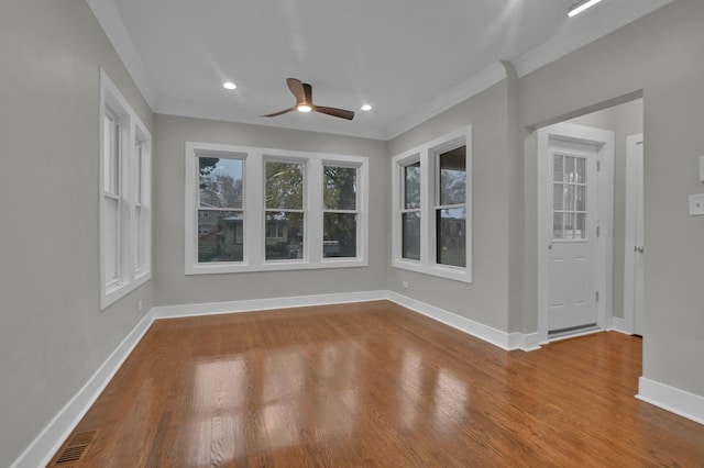 unfurnished room with hardwood / wood-style flooring, ceiling fan, and ornamental molding