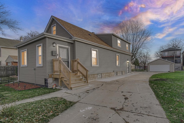 view of front of house with a garage and an outbuilding