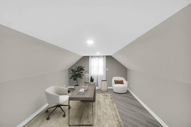 office space with light wood-type flooring and lofted ceiling