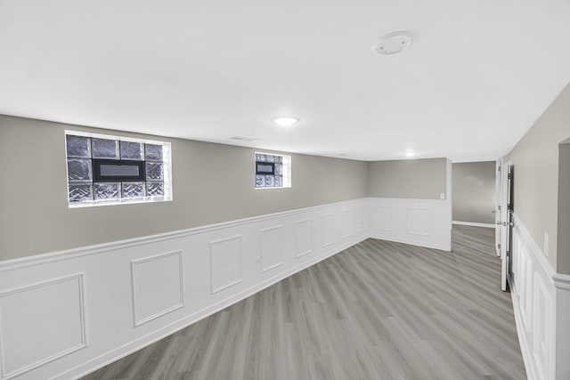 basement with light hardwood / wood-style floors