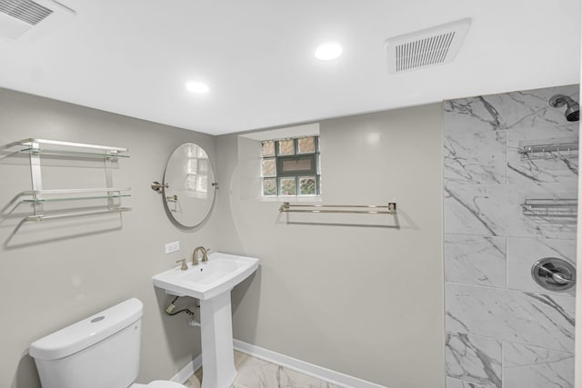 bathroom featuring toilet and tiled shower