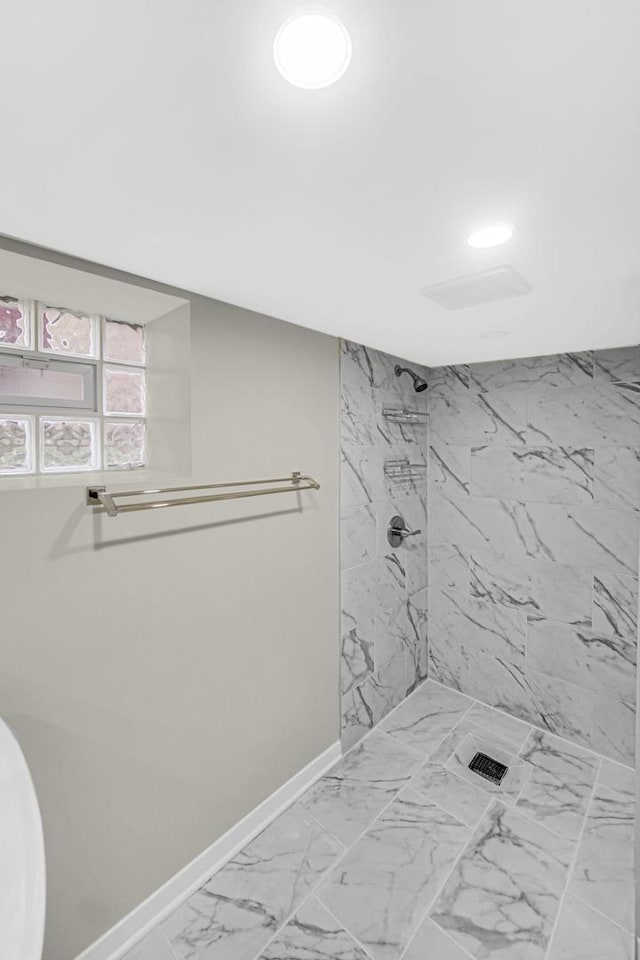 bathroom with tiled shower