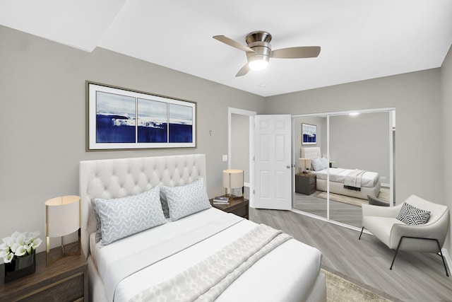 bedroom featuring hardwood / wood-style floors, a closet, and ceiling fan