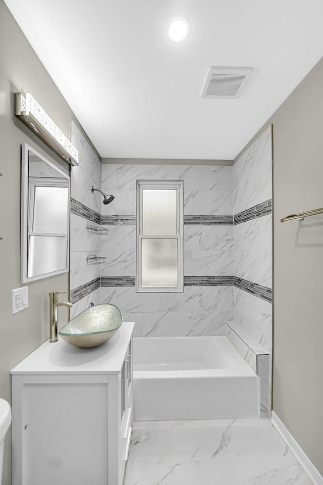 full bathroom featuring vanity, toilet, and tiled shower / bath