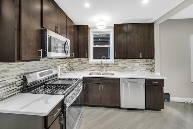 kitchen with dark brown cabinets, stainless steel appliances, and sink