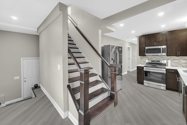 stairs featuring hardwood / wood-style flooring