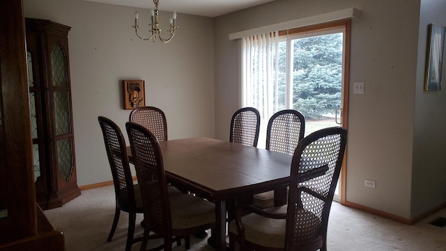 dining room with light carpet and a notable chandelier