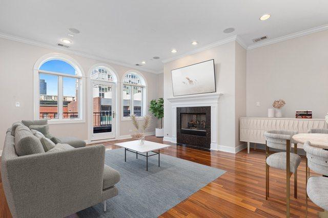 living room with hardwood / wood-style flooring and ornamental molding