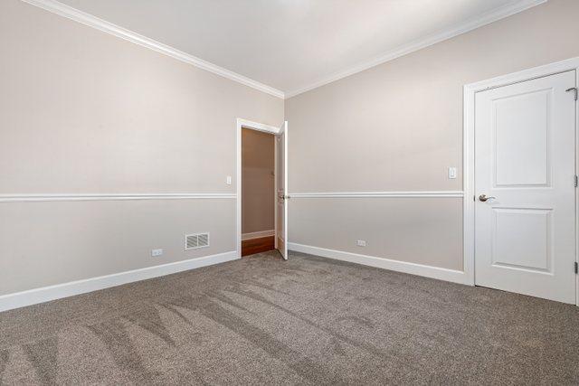 empty room with carpet and ornamental molding