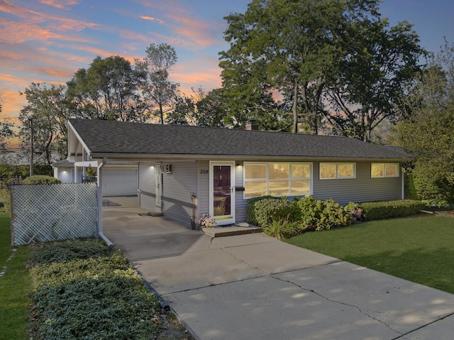 single story home with a lawn and a garage