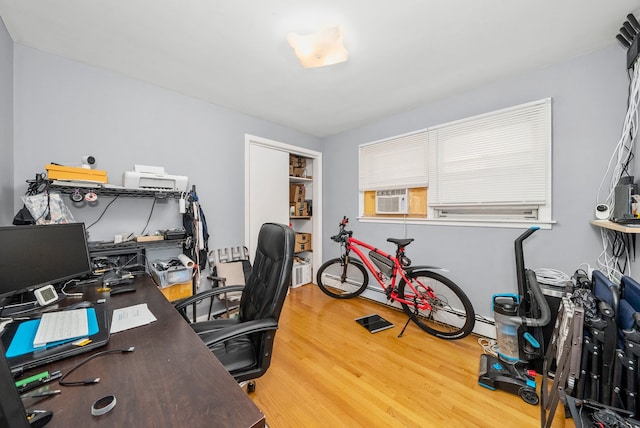 office featuring cooling unit and hardwood / wood-style flooring