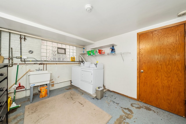 clothes washing area with washer and dryer and sink