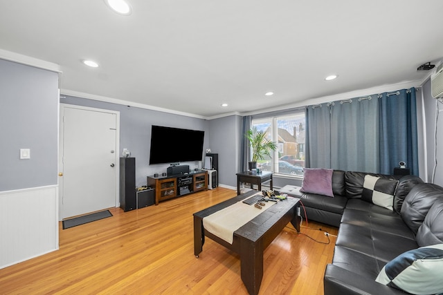 living room with crown molding and hardwood / wood-style flooring