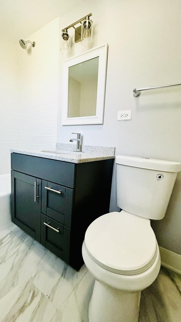 bathroom with vanity and toilet