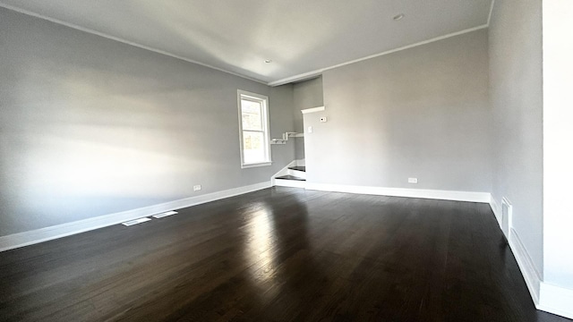 empty room with dark hardwood / wood-style flooring