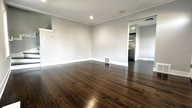 empty room with crown molding and dark hardwood / wood-style flooring