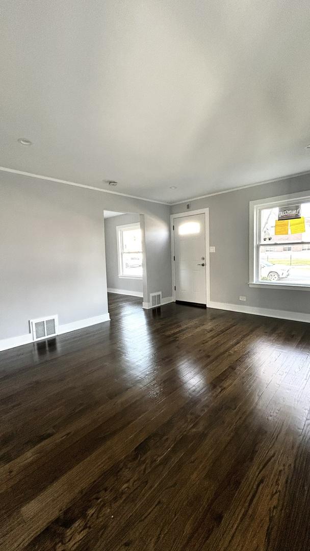 unfurnished living room featuring dark hardwood / wood-style floors