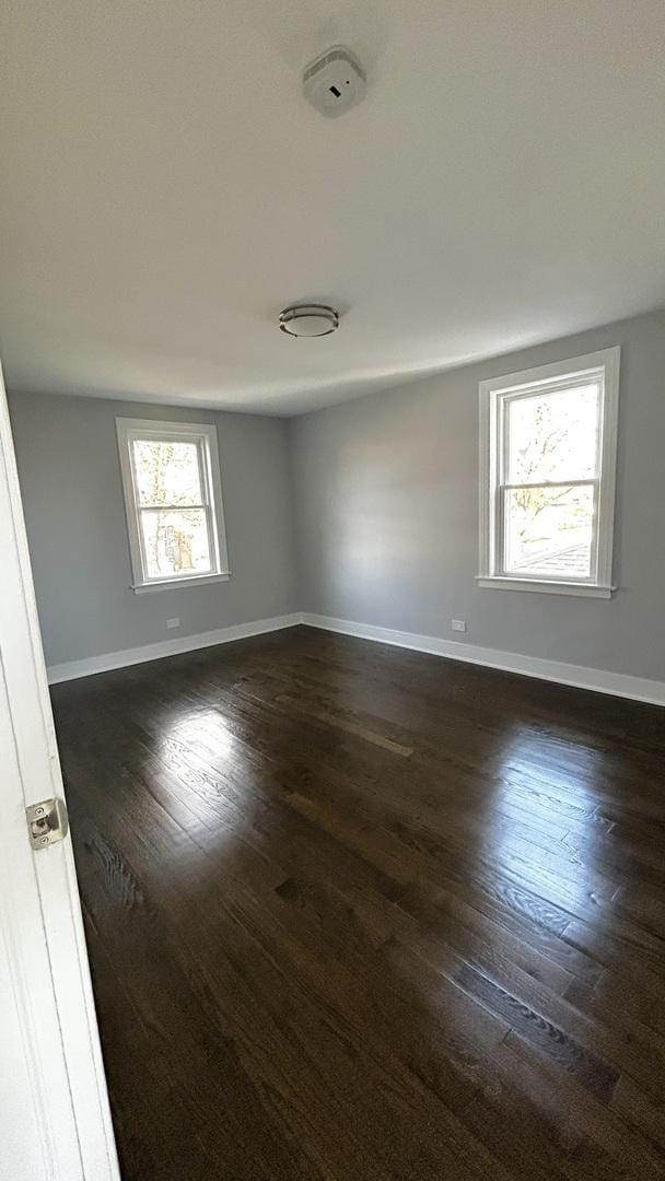 spare room featuring dark hardwood / wood-style flooring