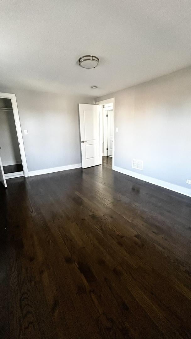 spare room featuring dark wood-type flooring