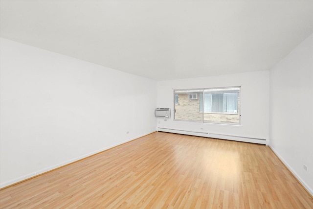 unfurnished room with light hardwood / wood-style floors, a wall unit AC, and baseboard heating