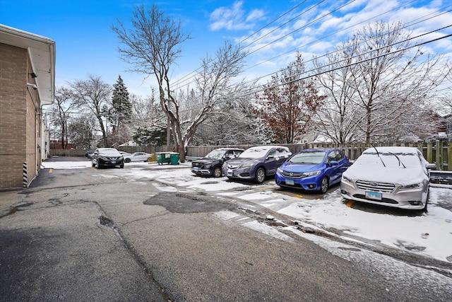 view of snow covered parking area