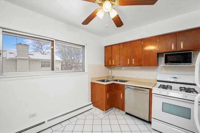 kitchen featuring a baseboard heating unit, sink, stainless steel dishwasher, tasteful backsplash, and white gas stove