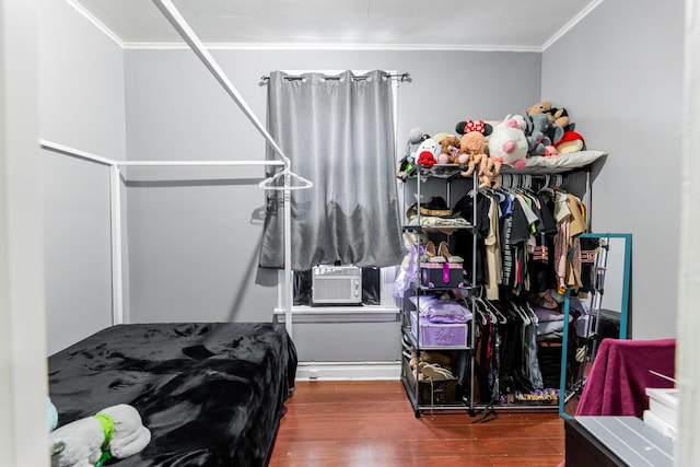 bedroom with hardwood / wood-style flooring, cooling unit, and crown molding