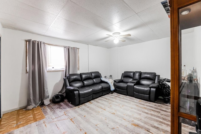 living room featuring a paneled ceiling, ceiling fan, and light hardwood / wood-style flooring