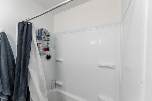 bathroom with shower / bath combination with curtain, ornamental molding, and tile walls