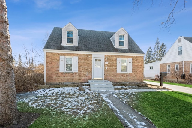 cape cod home with a yard