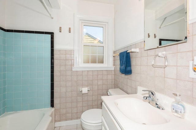 full bathroom with tile patterned floors, vanity, shower / washtub combination, tile walls, and toilet