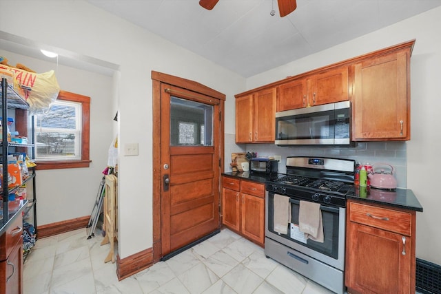 kitchen featuring decorative backsplash, ceiling fan, and stainless steel appliances