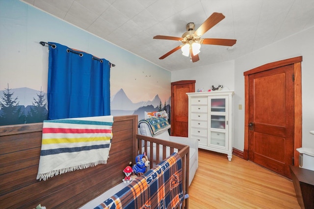 bedroom featuring light hardwood / wood-style flooring and ceiling fan