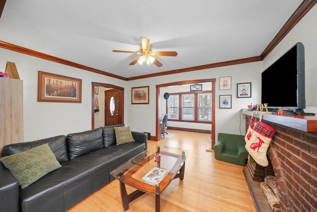 living room featuring ceiling fan, light hardwood / wood-style floors, and crown molding