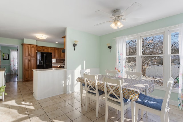 dining area with ceiling fan and light tile patterned flooring