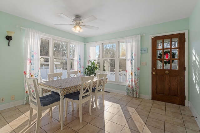 dining space featuring ceiling fan and light tile patterned floors